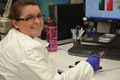 Happy Smiling Employee in Lab Coat